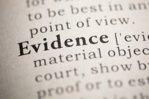 Closeup of a dictionary page showing "evidence" in bold